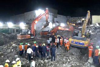 At least seven people have died and several others are feared trapped after a five-story building collapsed in Surat, Gujarat